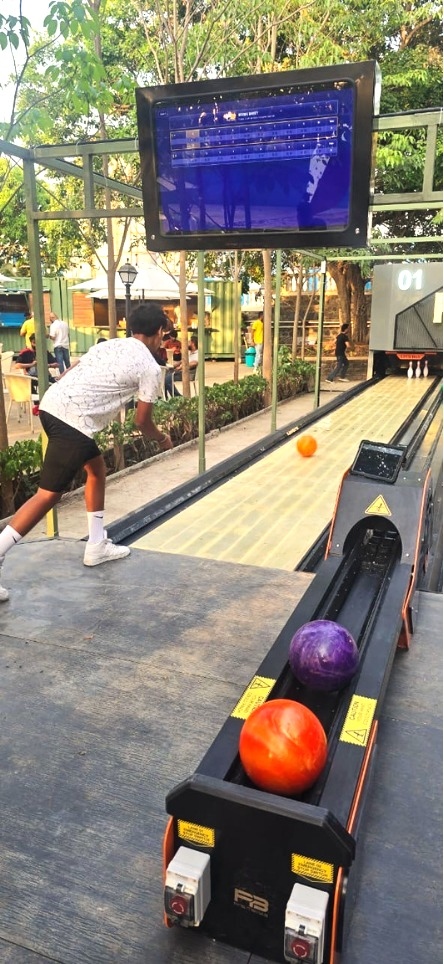Outdoor bowling lane with player preparing to bowl