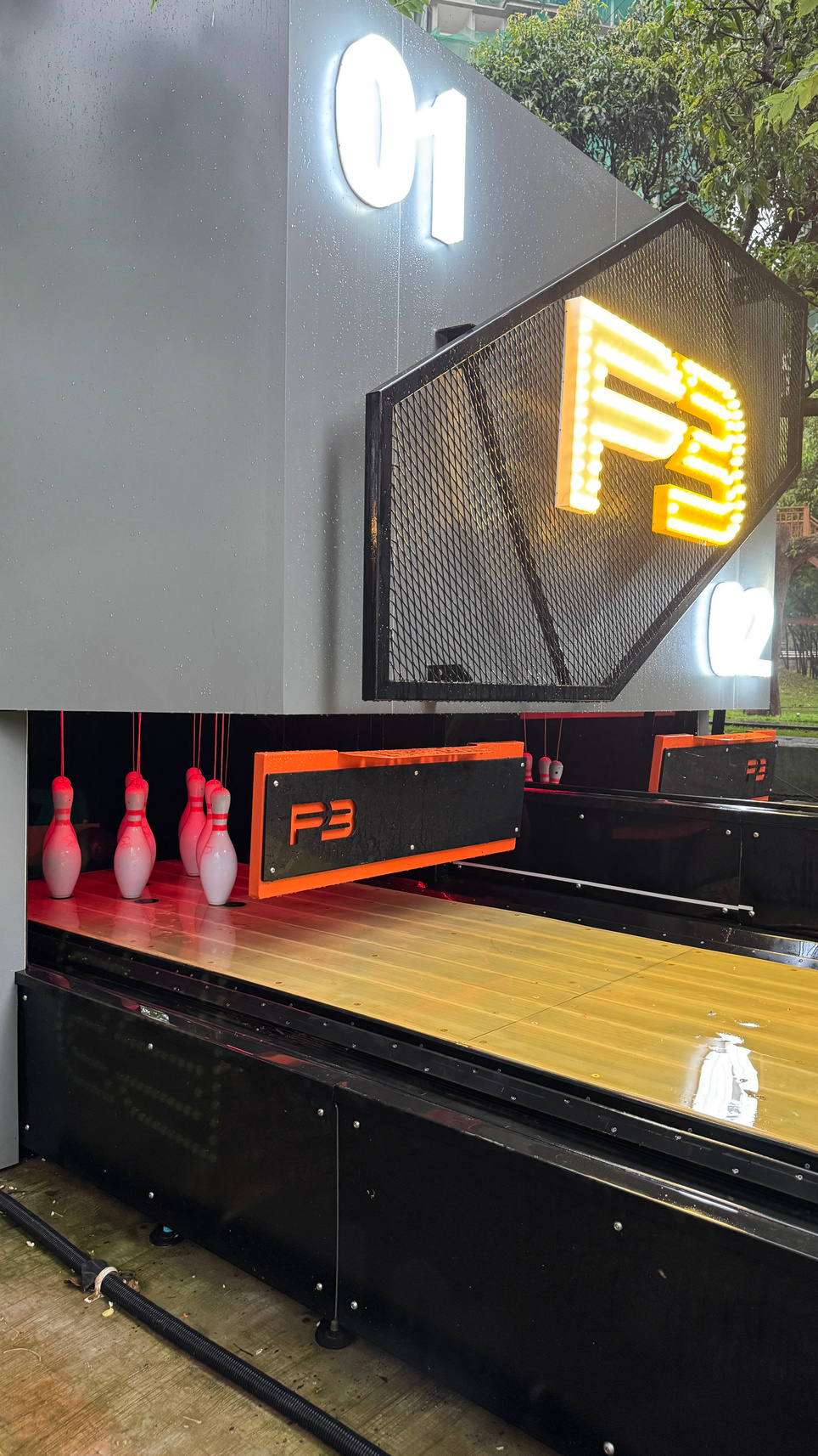 Close up of bowling pins and glowing logo sign